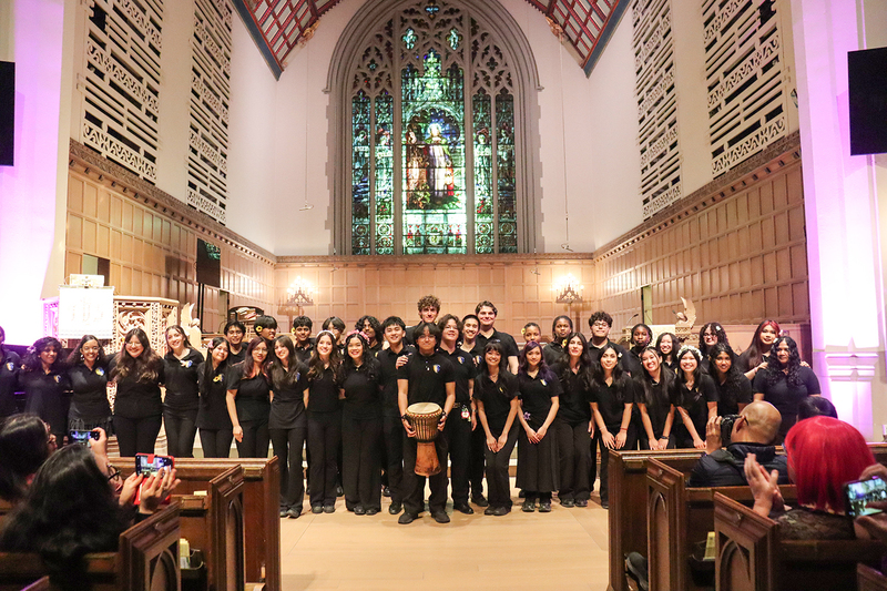 Group photo of the Senator O'Connor choir in Timothy Eaton Memorial Church with audience members in the pew