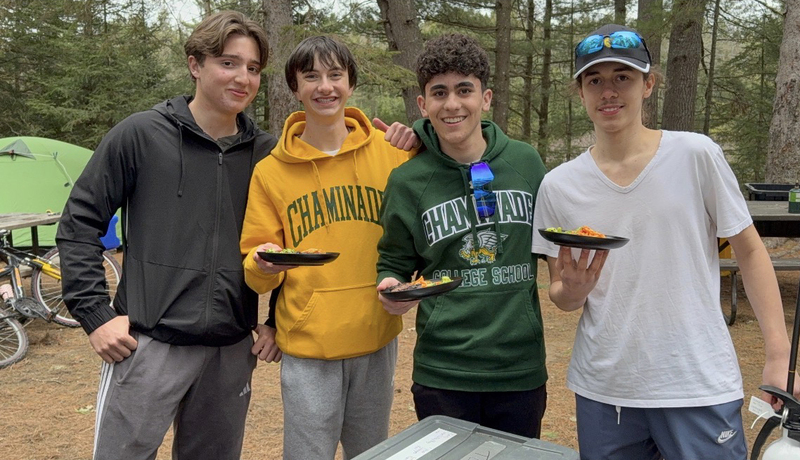 Photo of Chaminade students on the excursion holding up plates of food