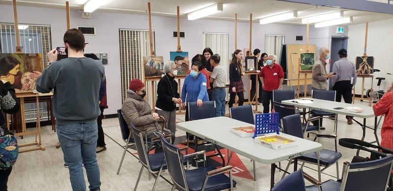 Students showcase art exhibits at Piece Out presentation while members of the school community look at the art Students showcase art exhibits at Piece Out presentation while members of the school community look at the art