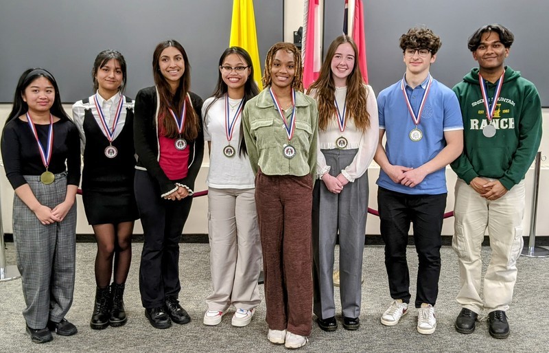 Winners of the Concours d'art Oratoire 2023 French Public Speaking Competition winners posing for a group photo with their medals