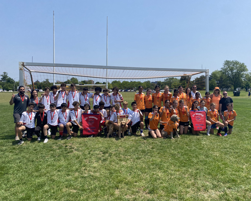 Group photo of both the St. Matthew boys team and St. Clement girls team on the soccer field