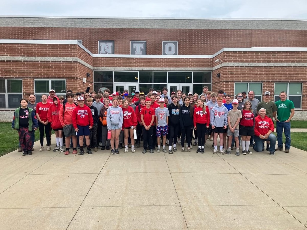 Seventh and eighth grade students pictured in front of the school before leaving for their cops and bobbers field trip.