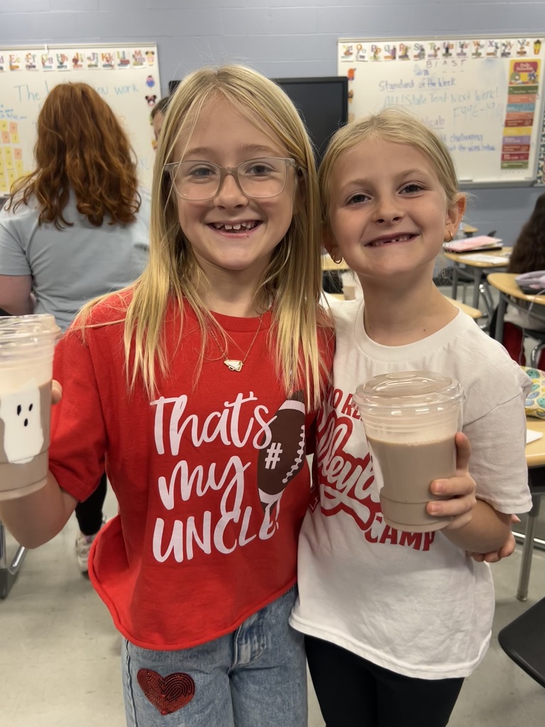 Child holding a drink with a ghost on it