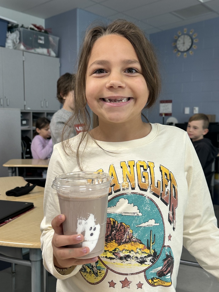 Child holding a drink with a ghost on it