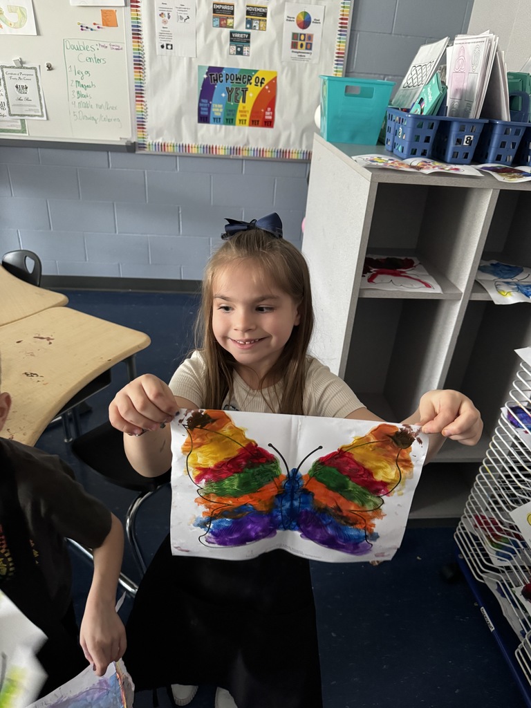 Student holding butterfly 
