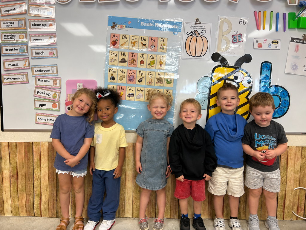 Toronto preschool students celebrate Backwards Day during Attendance Spirit Week. In the photos, students pose together showing both the fronts and backs of their outfits, with many wearing their shirts backwards for the special theme day. A smaller group of preschoolers also smiles together in their classroom while showing off their Backwards Day outfits.