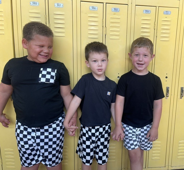 Toronto preschool students celebrate Twin Day during Attendance Spirit Week. In several photos, pairs and groups of students smile and pose together wearing matching or coordinated outfits, including checkered clothing, matching character shirts, colorful dresses, and matching friendship shirts.