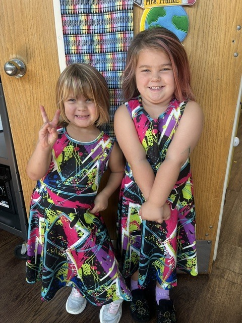 Toronto preschool students celebrate Twin Day during Attendance Spirit Week. In several photos, pairs and groups of students smile and pose together wearing matching or coordinated outfits, including checkered clothing, matching character shirts, colorful dresses, and matching friendship shirts.