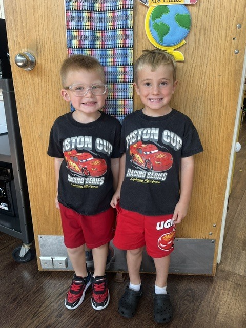 Toronto preschool students celebrate Twin Day during Attendance Spirit Week. In several photos, pairs and groups of students smile and pose together wearing matching or coordinated outfits, including checkered clothing, matching character shirts, colorful dresses, and matching friendship shirts.