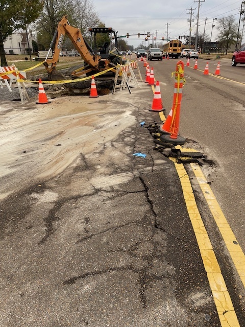Picture looking down a roadway with construction equipment blocking several lanes.