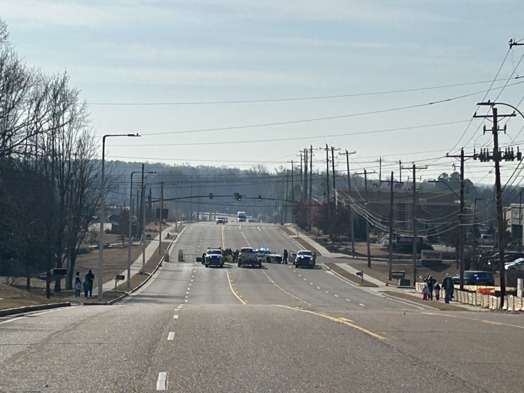 police cars blocking a roadway