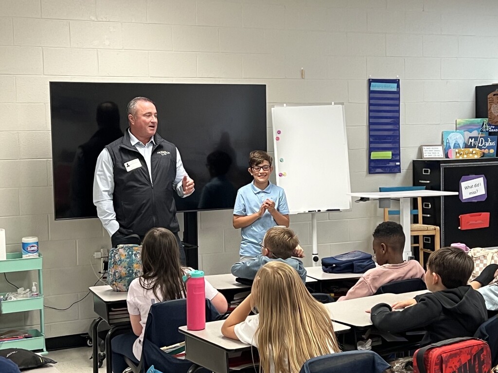 Mayor Wissman and student standing at the front of a classroom of students