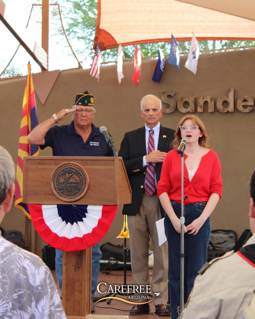 Singer and men saluting