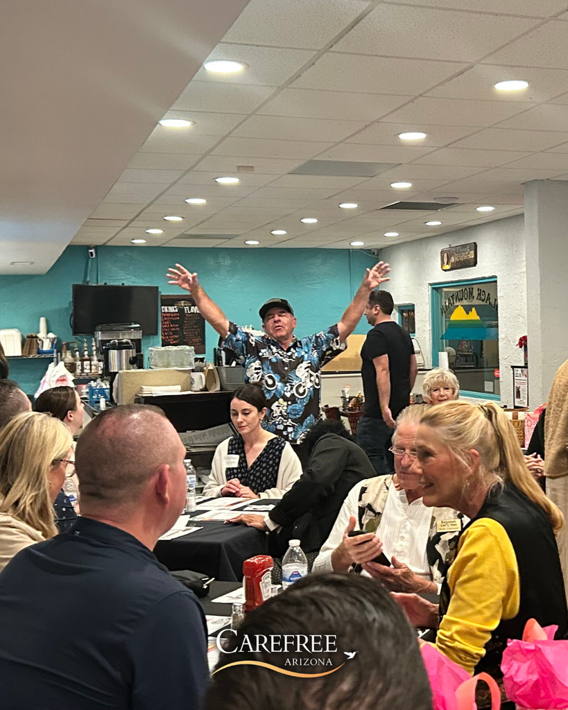 Man with arms raised speaking to crowd