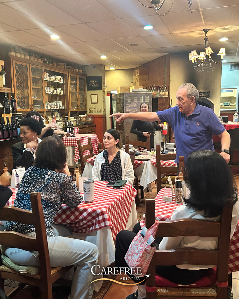 Man speaking and pointing to a group