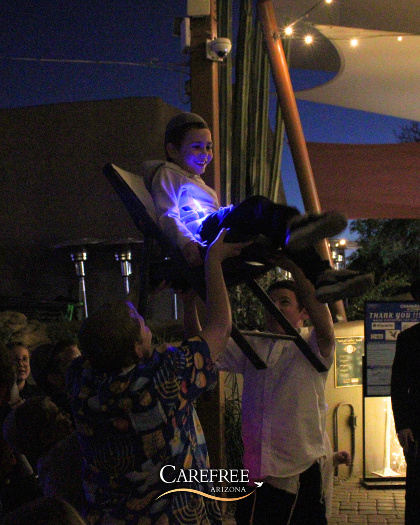 Young being lifted in his chair