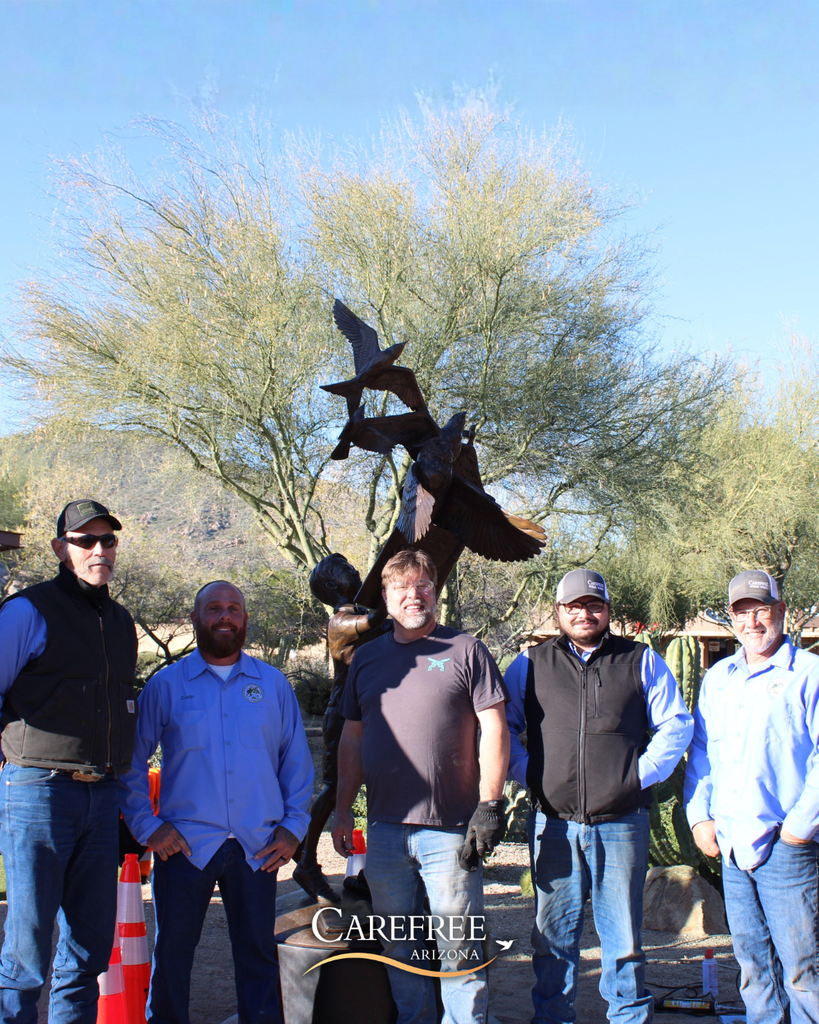 Public works team and Bryce Pettit Posing Near Sculpture