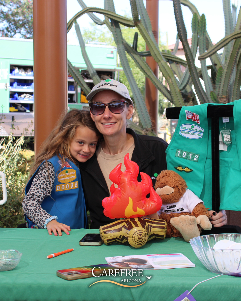 Girl scout and her mom posing for a photo