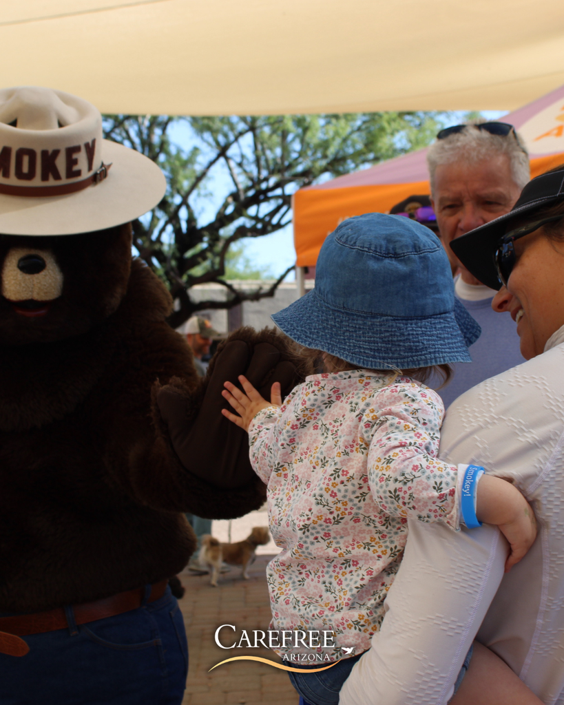 Smokey Bear and little girl high fiving