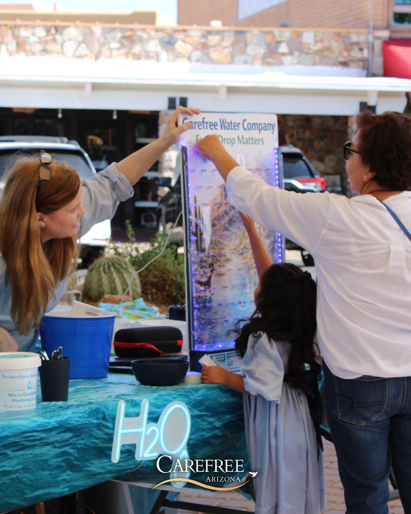Little girl playing plinko game with Carefree Water Company
