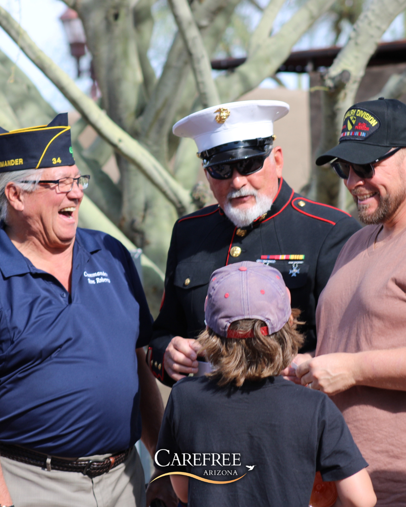 Three men laughing with boy