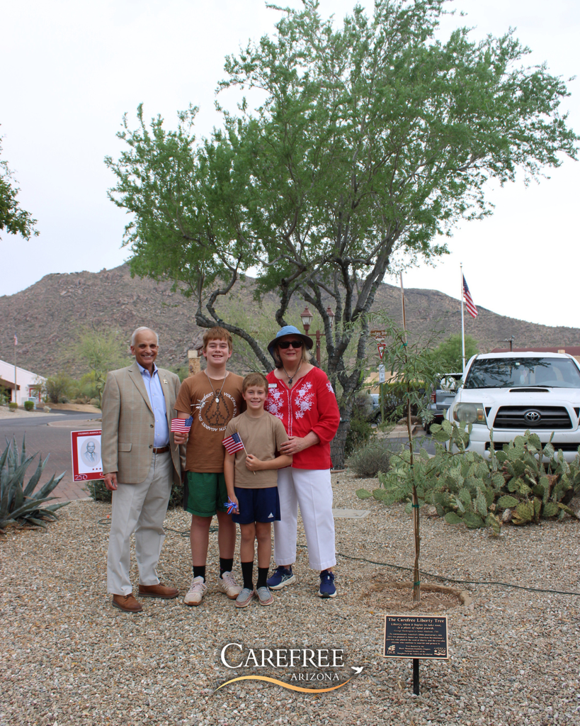 Mayor John Crane, Cynthia Kiefer and her nephews posed next to the Liberty Tree