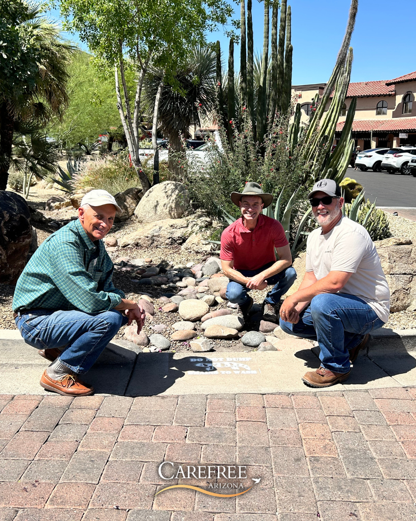 Mayor, Town Engineer and Public Works posing next to new storm drain painting