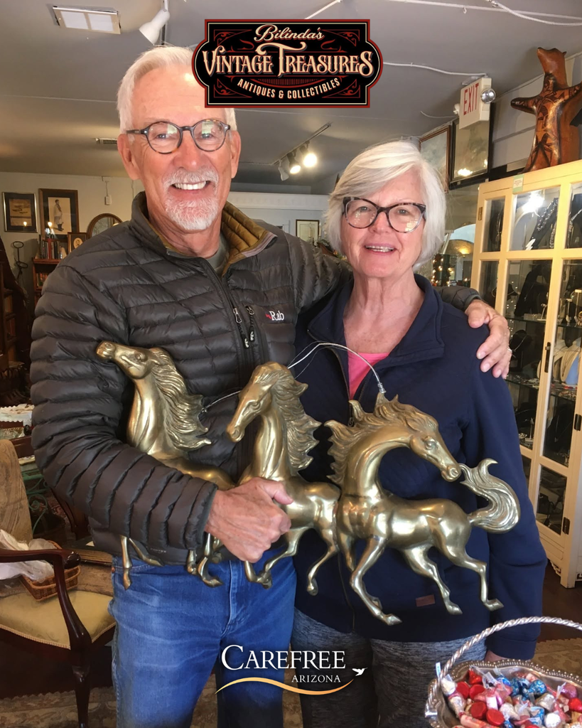 Couple holding horse art piece