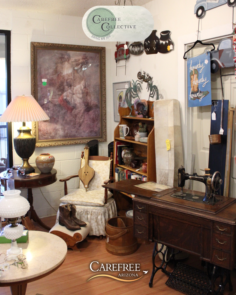 Cozy vintage room with an antique sewing machine, wooden furniture, and framed artwork on white brick walls.