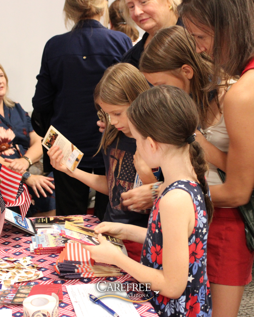 Kids at NSDAR table grabbing patriotic materials