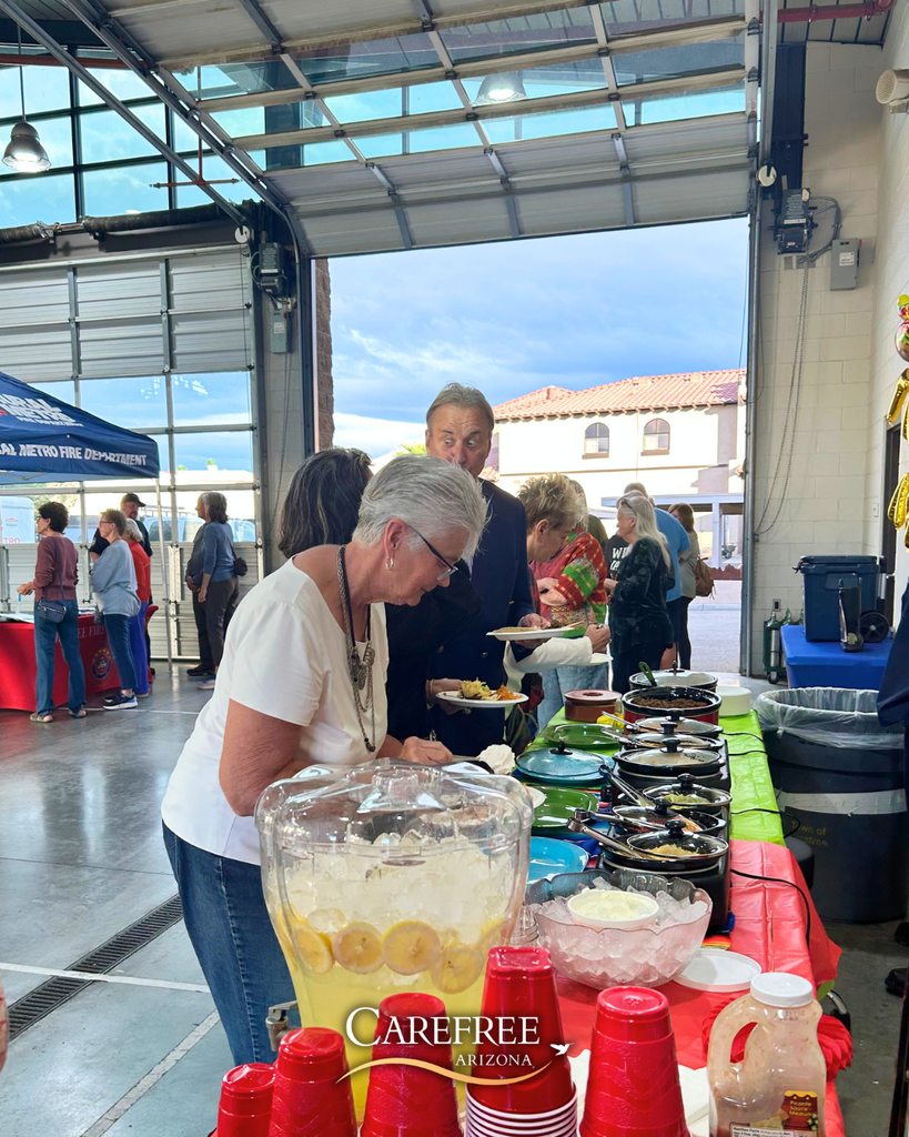 People in line making tacos