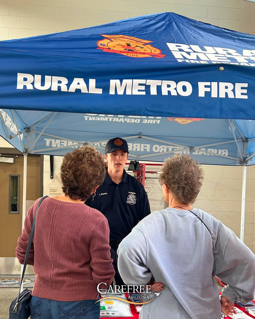 Two women talking to fire fighter