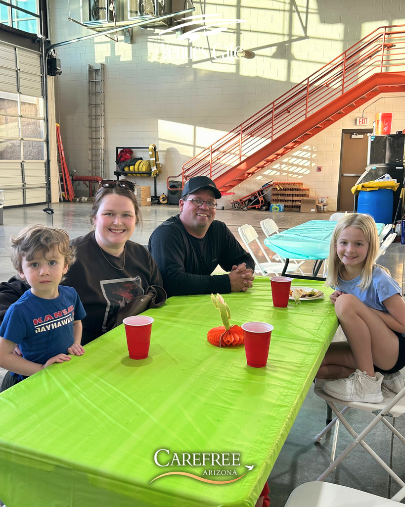 Family of 4 smiling at camera