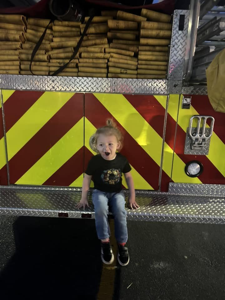 Happy child on the back of a fire truck