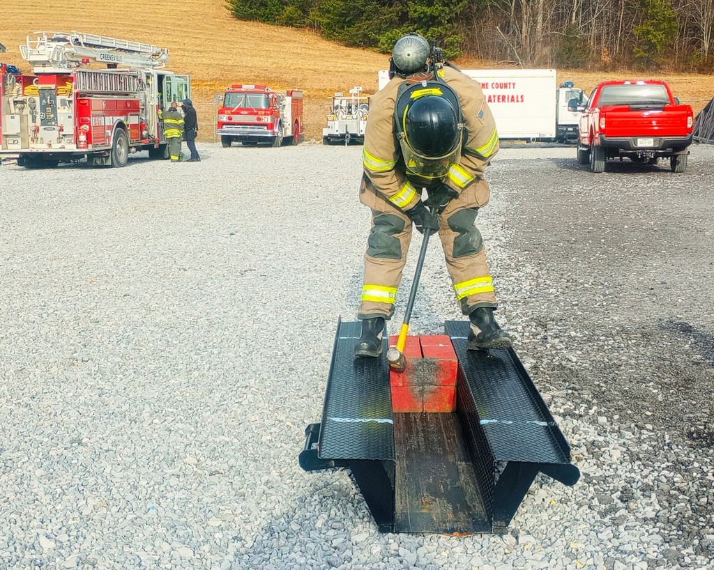 firefighter using sledge hammer
