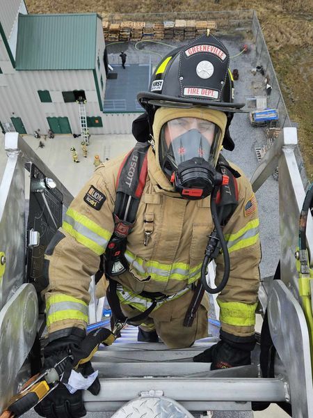 GFD Firefighter at the top of ladder
