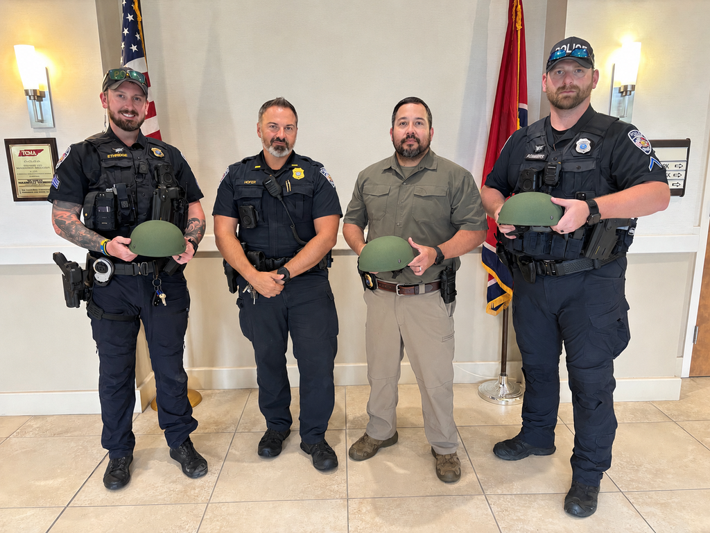 Sgt. Ethridge, Lt. Hofer, Sgt. Duenez, and Officer Chambers standing with three ballistic helmets donated by the United States Deputy Sheriff's Association