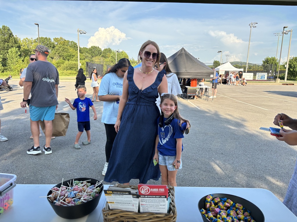 Woman and child posing for a picture at First Friday Celebration