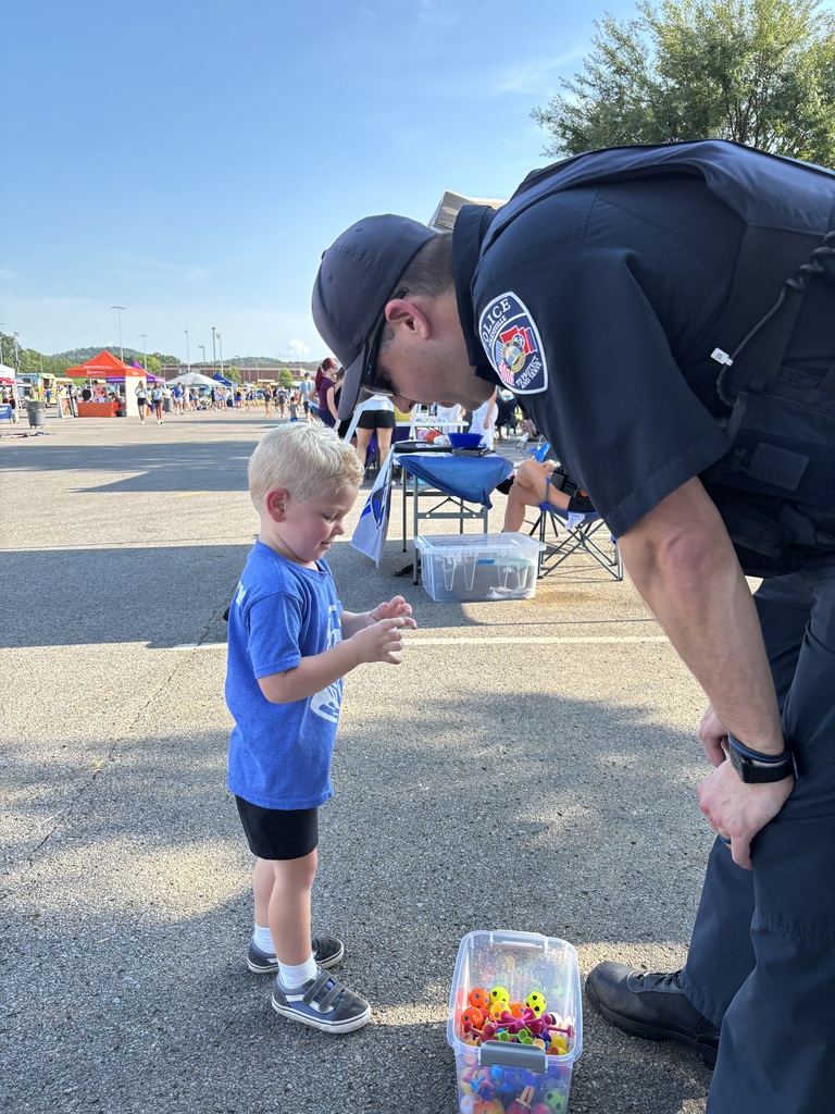 Officer Bates handing our toys to visitors at First Friday Celebration