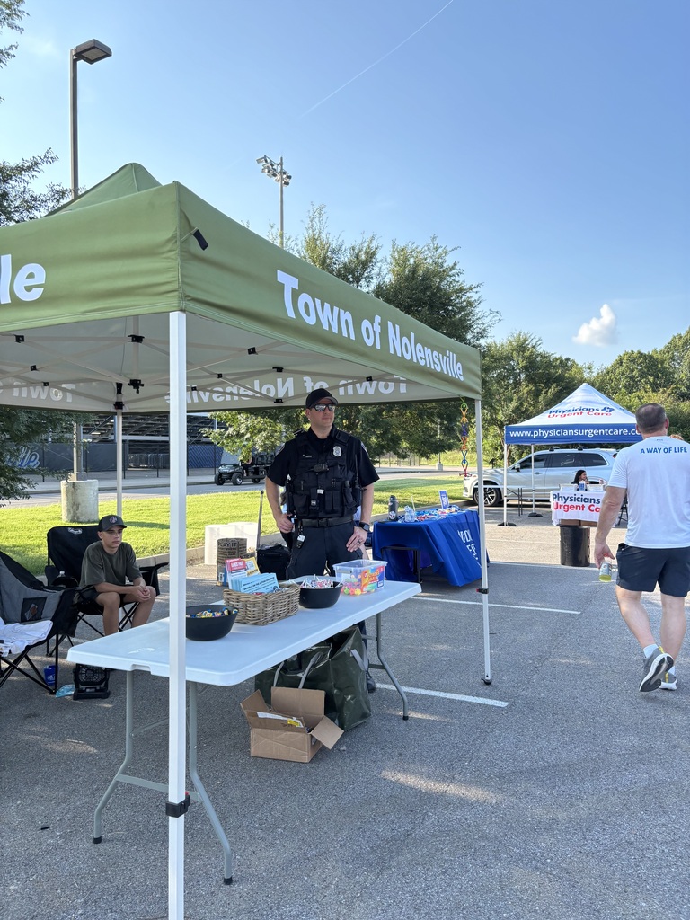 Officer Bates at First Friday Celebration standing in the Town of Nolensville tent