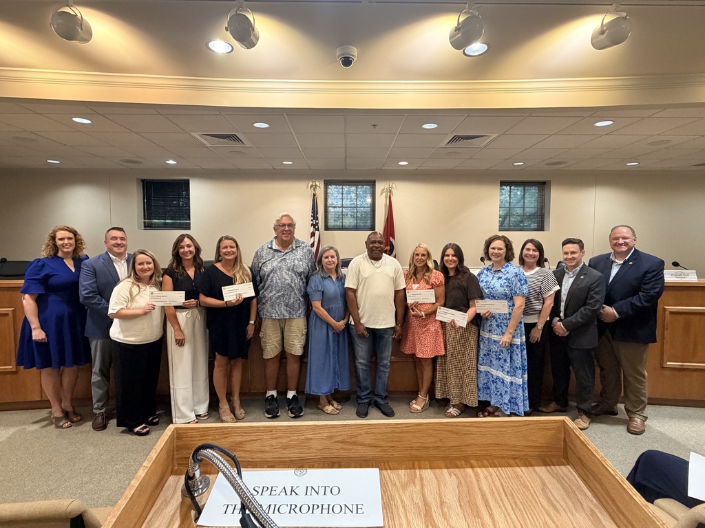 Town of Nolensville Board of Commissioners with representatives of local Nolensville schools accepting a check donation from the Historic Nolensville Buttercup Festival Committee