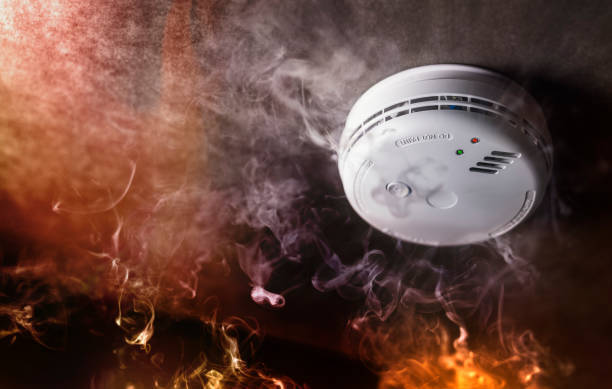 an Image of a smoke detector with smoke around it