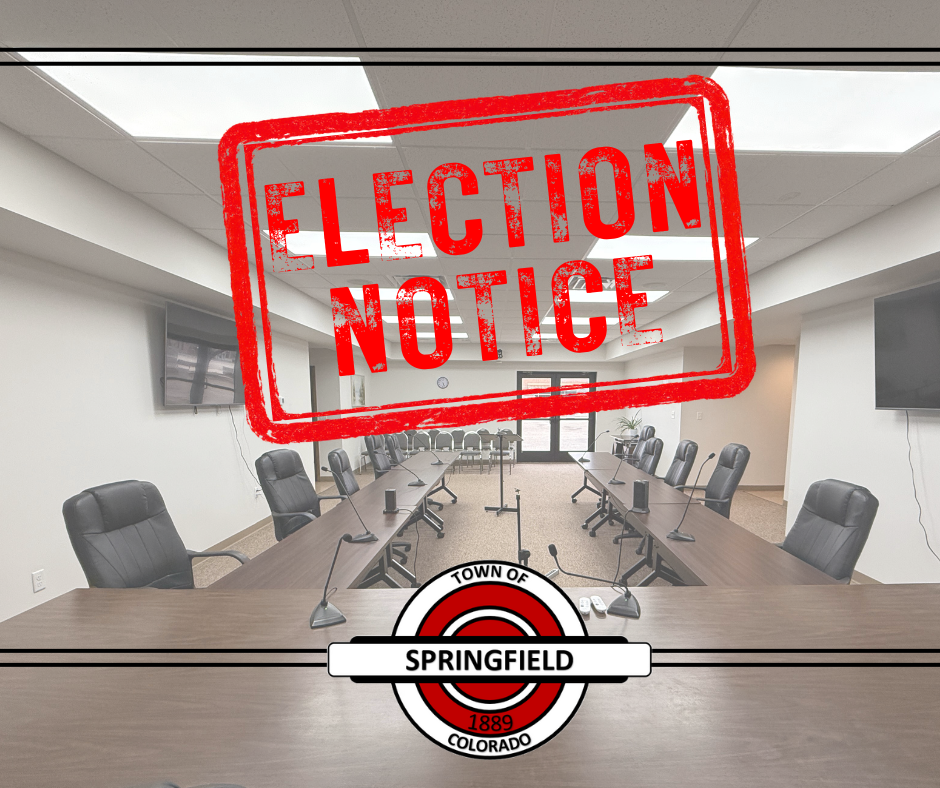 Photo of a town council meeting room with long tables, microphones, and empty chairs. A large red stamped-style graphic reading ‘ELECTION NOTICE’ is overlaid across the image. At the bottom is the Town of Springfield, Colorado seal with the year 1889