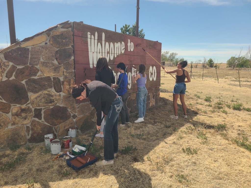 Group of high school kids painting the welcome sign for Springfield, CO!