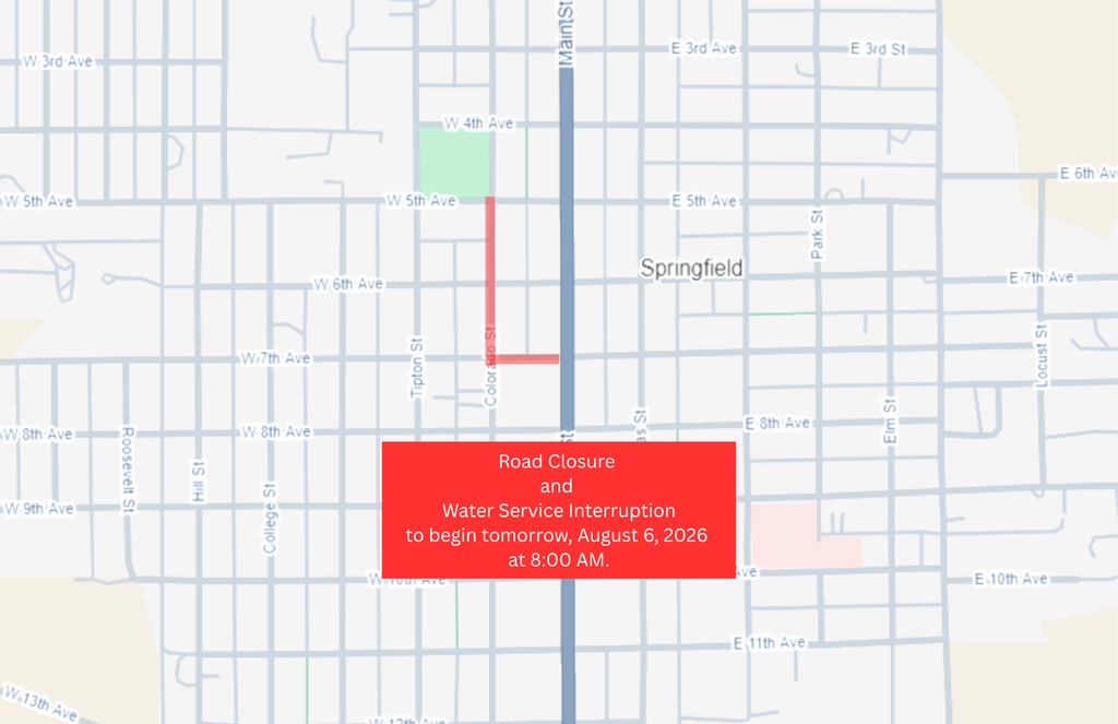 Map of Springfield, Colorado, showing a planned road closure and water service interruption. The affected streets are highlighted in red, including a section of Colorado Street between West 5th Avenue and approximately West 7th Avenue, with an additional closure extending east from Colorado Street to Main Street. A red text box near the bottom of the map reads: "Road Closure and Water Service Interruption to begin tomorrow, August 6, 2026 at 8:00 AM." The rest of the town street grid is shown in light gray for reference.