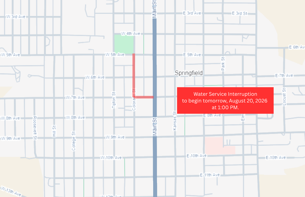Map of Springfield, Colorado, showing a planned road closure and water service interruption. The affected streets are highlighted in red, including a section of Colorado Street between West 5th Avenue and approximately West 7th Avenue, with an additional closure extending east from Colorado Street to Main Street. A red text box near the bottom of the map reads: "Road Closure and Water Service Interruption to begin tomorrow, August 20, 2026 at 1:00 PM.