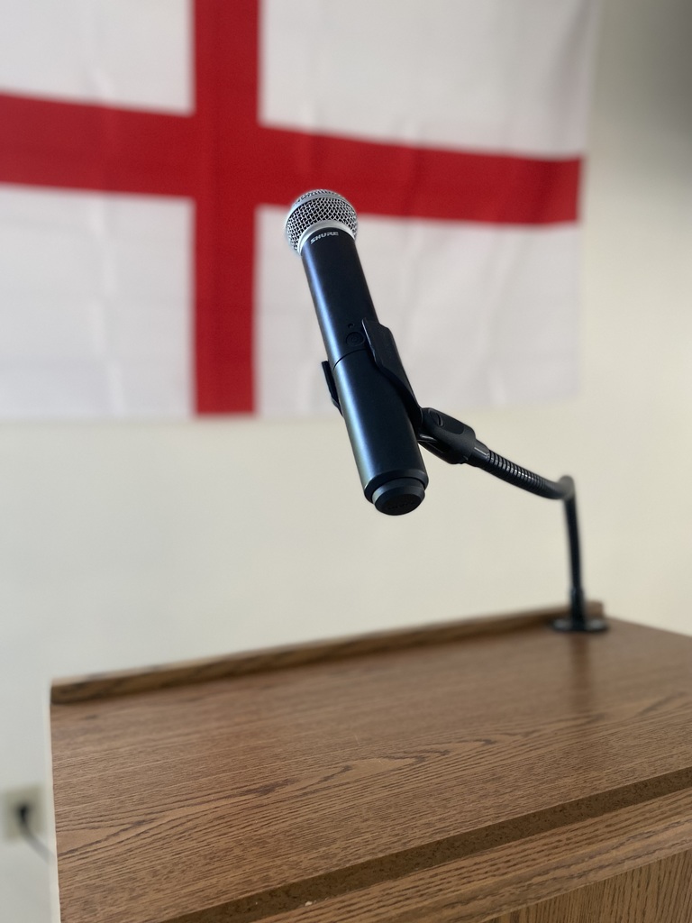 Mic in front of St. George flag