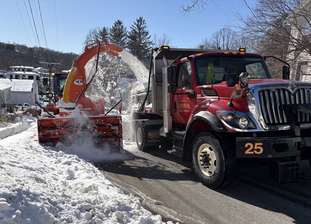 Big snowblower filling dump truck with snow