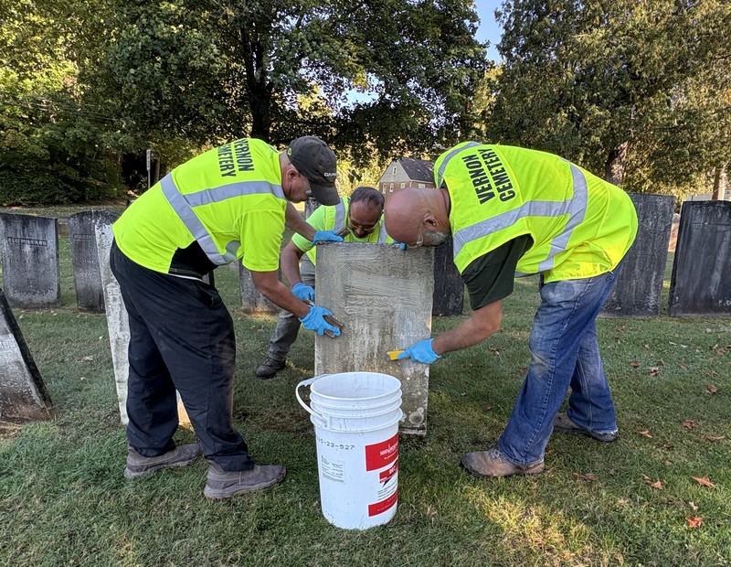 Workers clean a stone