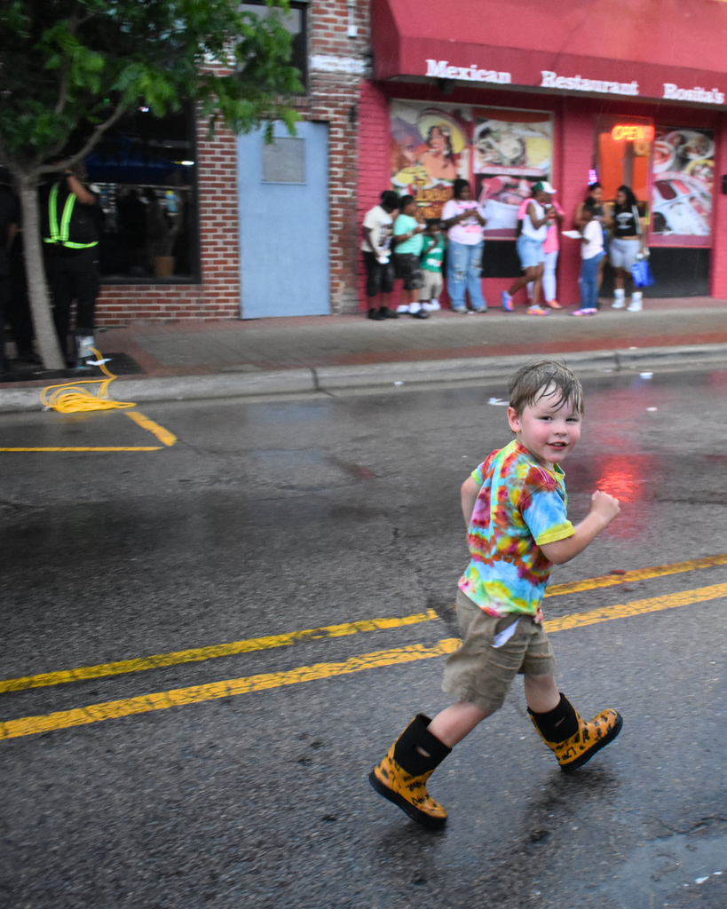 little boy in the rain at spring fest